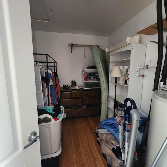 interior space with dark hardwood / wood-style flooring and water heater