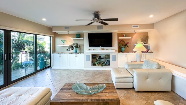 tiled living room featuring built in features and ceiling fan