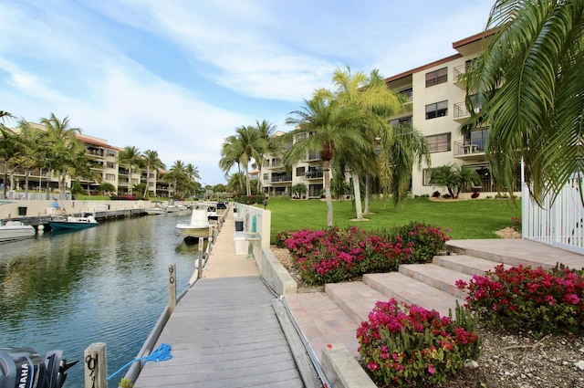 dock area featuring a water view and a lawn