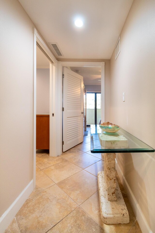 hall with light tile patterned floors