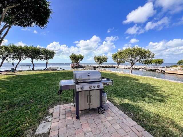 view of patio featuring a water view and a grill