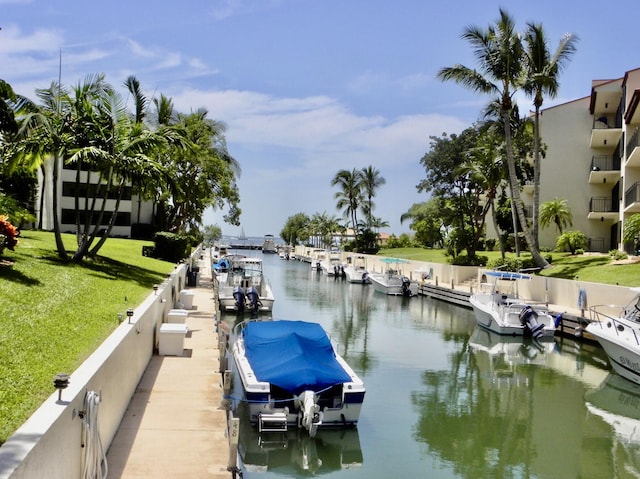 dock area with a water view and a yard