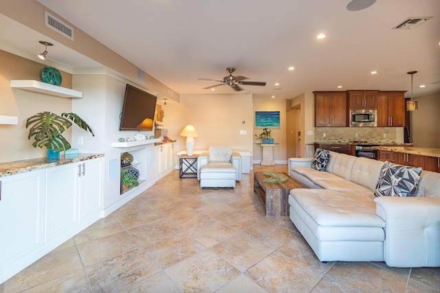 living room featuring ceiling fan and a fireplace