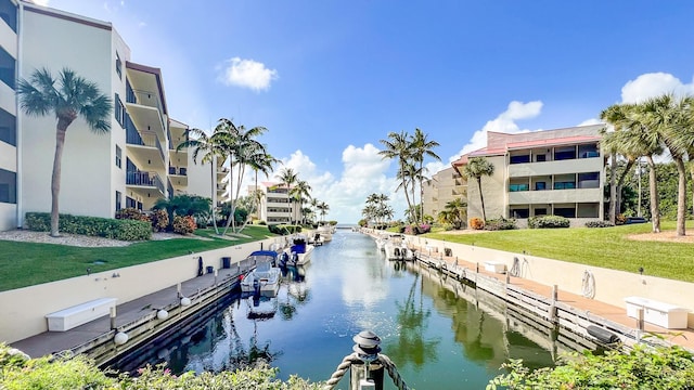 dock area featuring a water view and a lawn