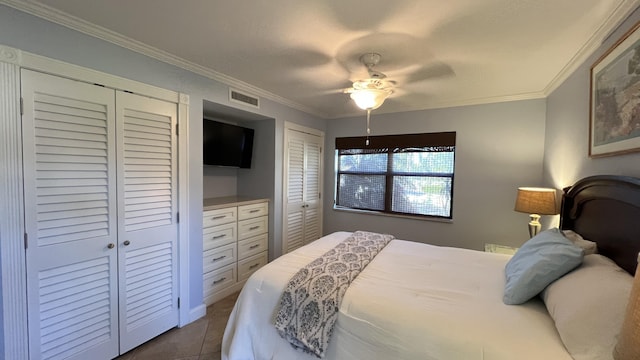 tiled bedroom with multiple closets, ceiling fan, and crown molding