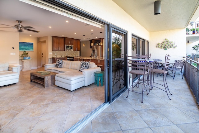 interior space with ceiling fan and an outdoor hangout area