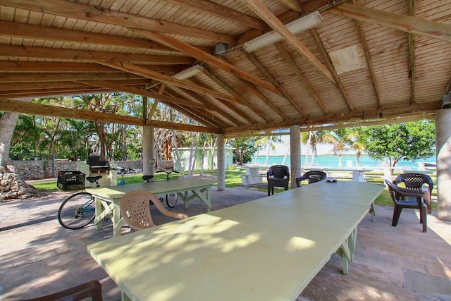 view of patio / terrace featuring a gazebo, a beach view, and a water view