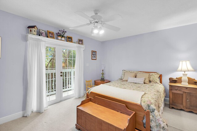 bedroom featuring access to exterior, light colored carpet, french doors, and ceiling fan