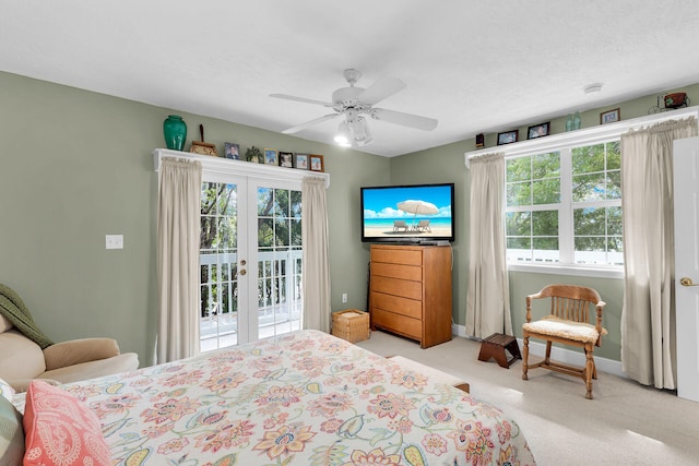 carpeted bedroom with a textured ceiling, access to outside, french doors, and ceiling fan