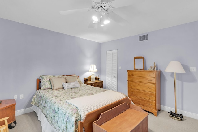 bedroom with light carpet, a closet, and ceiling fan