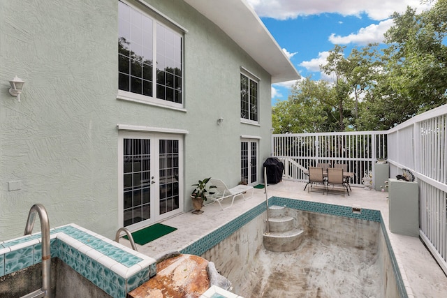 view of pool with a patio area and french doors