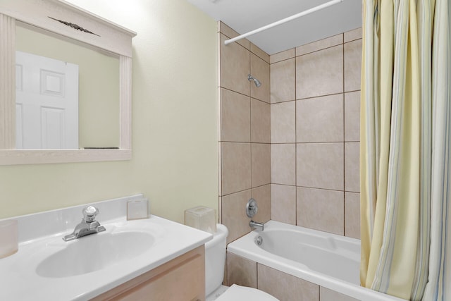 full bathroom featuring toilet, vanity, and shower / bathtub combination with curtain