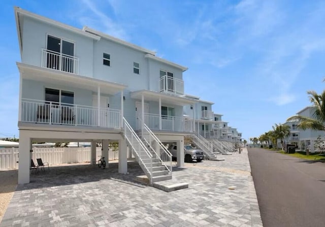 exterior space with stairs, a porch, and fence