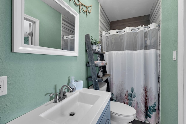 bathroom with vanity, toilet, and curtained shower