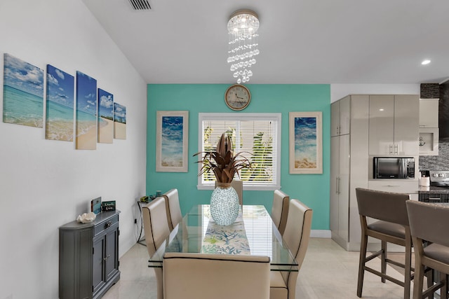 tiled dining area featuring a notable chandelier