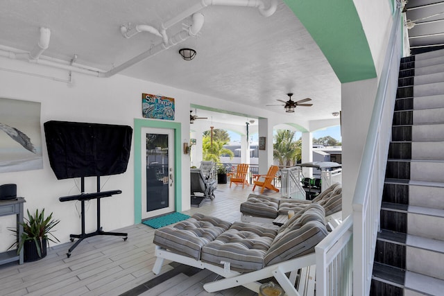 wooden terrace featuring ceiling fan