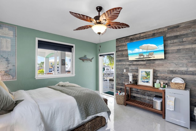 tiled bedroom with ceiling fan and wood walls