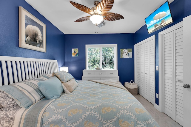 bedroom with multiple closets and ceiling fan