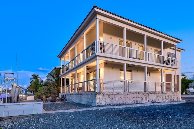 exterior space with a balcony and ceiling fan