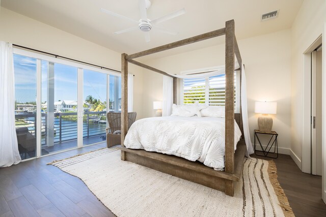 bedroom featuring dark hardwood / wood-style flooring, access to outside, and ceiling fan