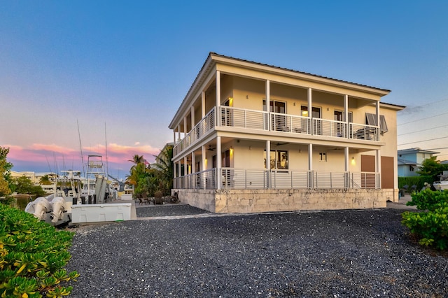 exterior space featuring a hot tub and a balcony