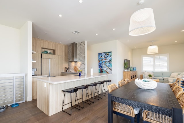 dining space with dark wood-type flooring and sink