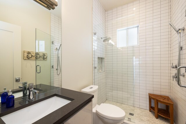 bathroom with vanity, an enclosed shower, and toilet