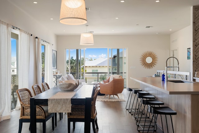 dining area with dark hardwood / wood-style floors and sink