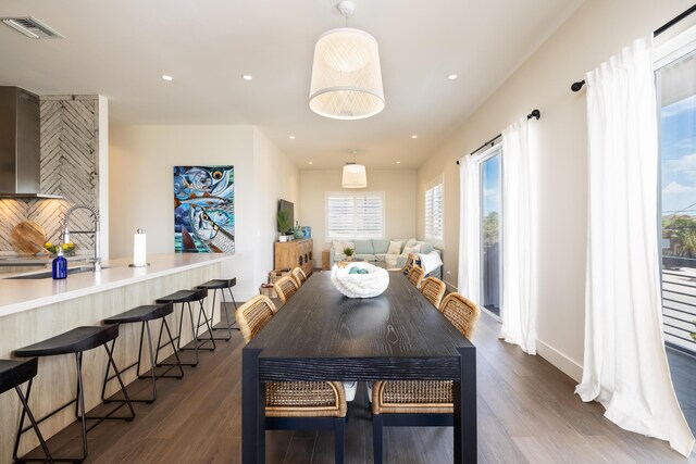 dining room with dark hardwood / wood-style floors and sink