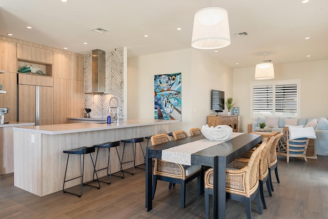 dining room with dark hardwood / wood-style flooring and sink