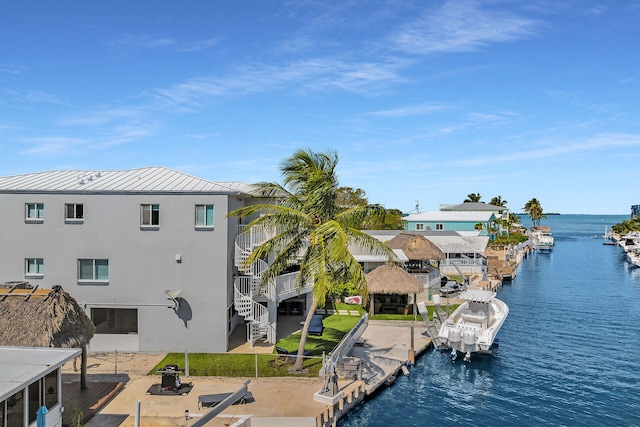 property view of water featuring a dock and stairs