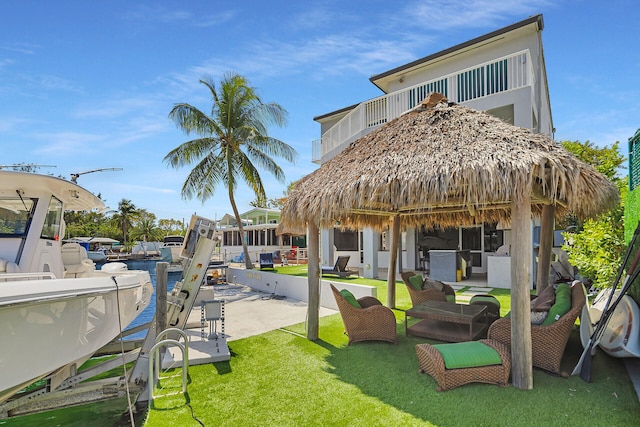 view of patio featuring a balcony and a dock