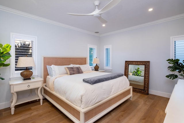 bedroom featuring wood-type flooring, ornamental molding, and ceiling fan