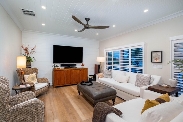 living room featuring ceiling fan, ornamental molding, light hardwood / wood-style floors, and wooden ceiling