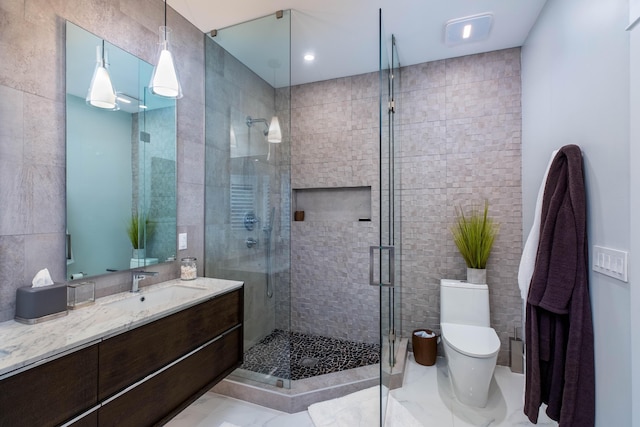 bathroom with walk in shower, tile walls, vanity, and toilet