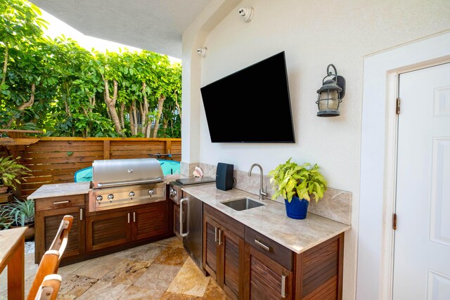 view of patio / terrace featuring area for grilling and sink