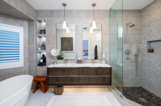 bathroom with tile walls, vanity, and plus walk in shower