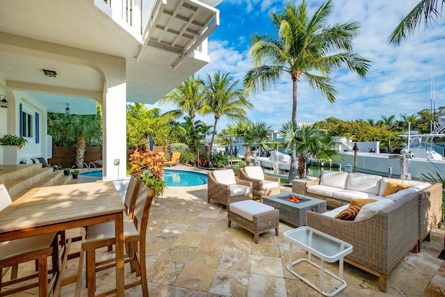 view of patio / terrace with an outdoor living space with a fire pit