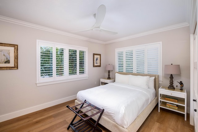 bedroom with hardwood / wood-style flooring, ceiling fan, and ornamental molding