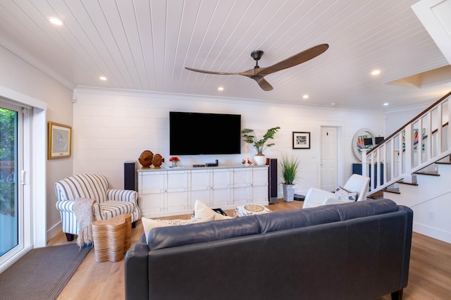 living room featuring ornamental molding, wooden ceiling, ceiling fan, and light wood-type flooring