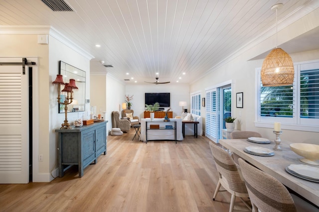 dining room with ornamental molding, light wood-type flooring, and wooden ceiling