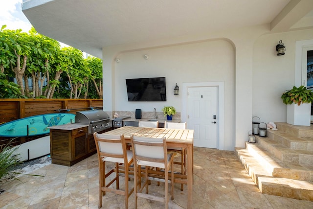 view of patio featuring grilling area, exterior kitchen, and sink