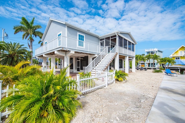 coastal inspired home featuring a patio and a sunroom