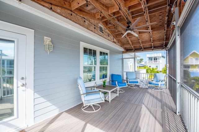 sunroom / solarium featuring lofted ceiling and ceiling fan