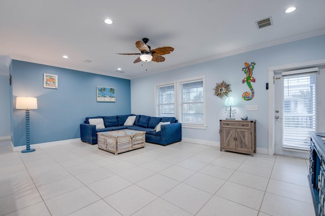 living room with ornamental molding, a wealth of natural light, and light tile patterned floors