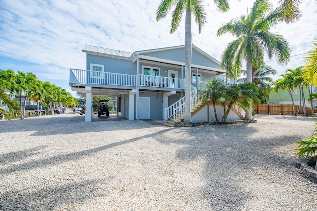 back of property featuring a carport and a porch