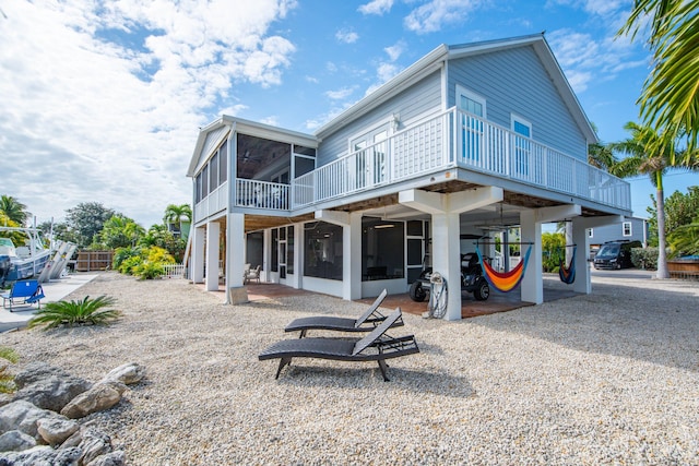 back of house with a sunroom and a patio area