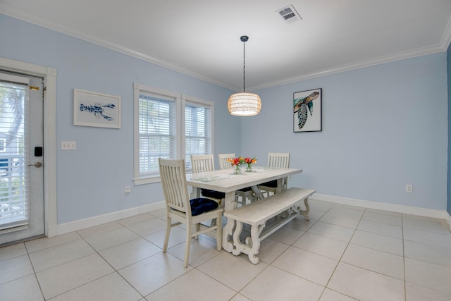 dining area featuring ornamental molding and light tile patterned flooring