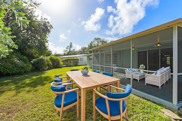 view of yard with an outdoor living space and a sunroom