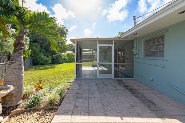 view of patio featuring a sunroom